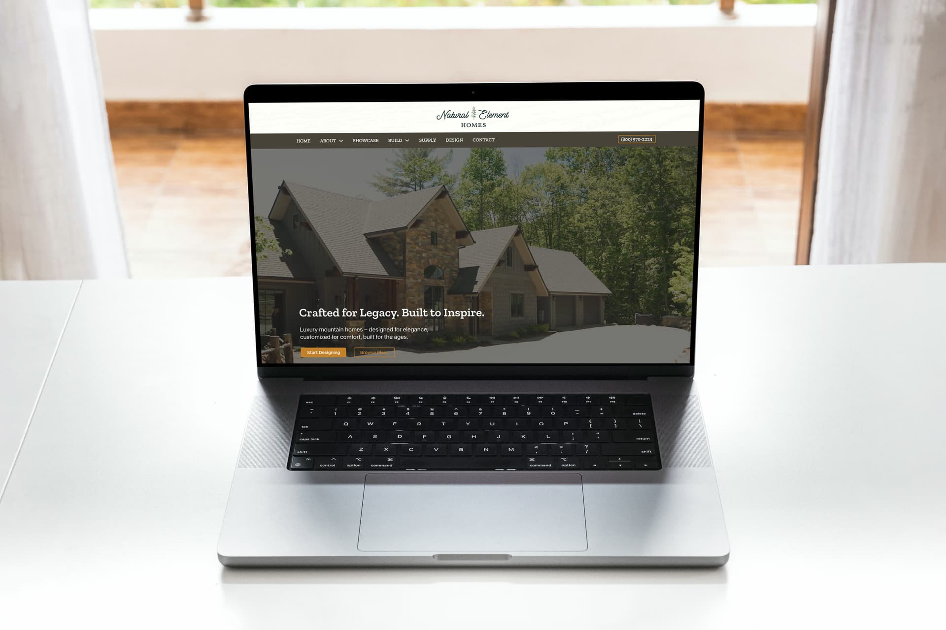 Natural Element Homes website on laptop