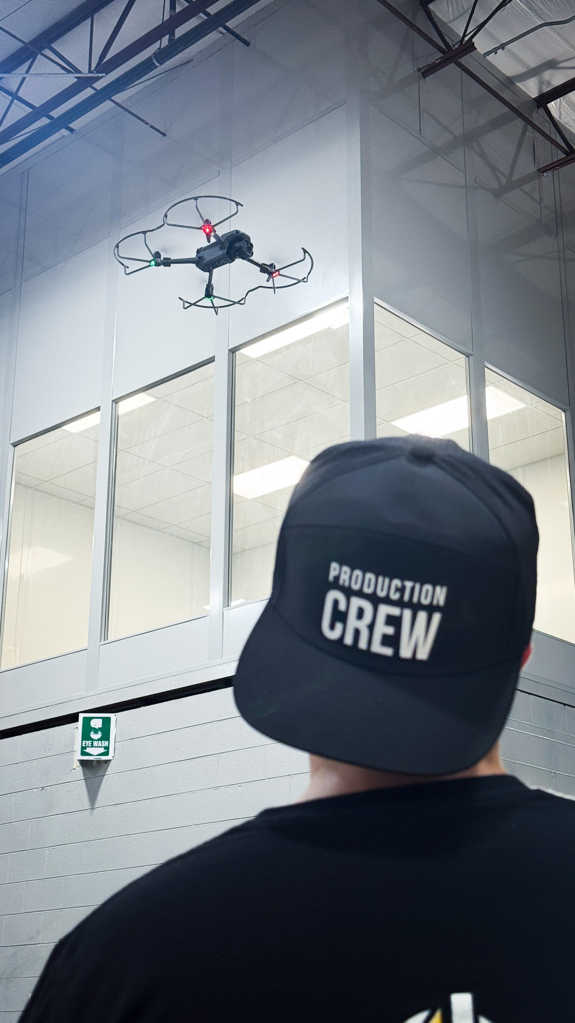 Production crew flying drone on set